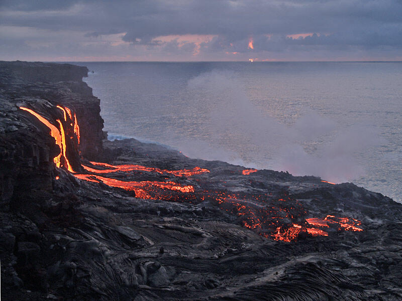 This is a photo of lava in PKK flow falling down old sea cliff inboard of old Lae`apuki delta, flowing across the old delta.