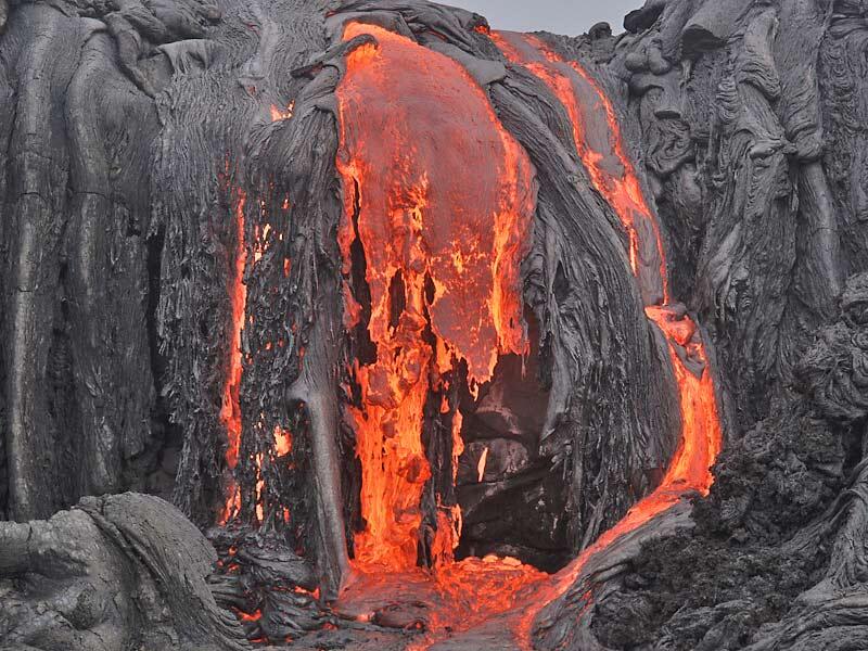 This is a photo of a gush of lava coming down an old sea cliff.