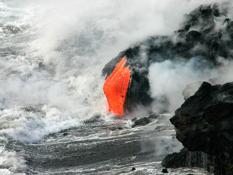 This is a photo of liquid lava falling from front of new delta and being quenched to rock by the water.