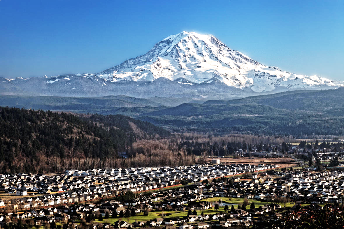 A distant view of Mount Rainier volcano over Puyallup Valley, near Orting, Washington.