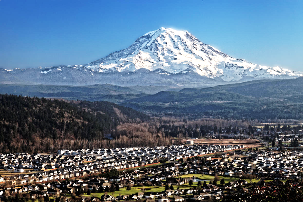  A distant view of Mount Rainier volcano over Puyallup Valley, near Orting, Washington.