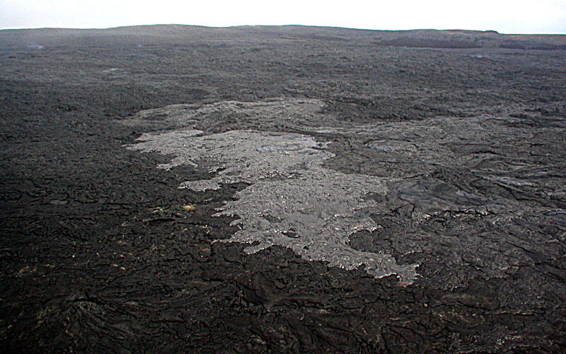 This is a photo of an active pahoehoe flow breaking out of PKK tube on gentle slope above Pulama pali.