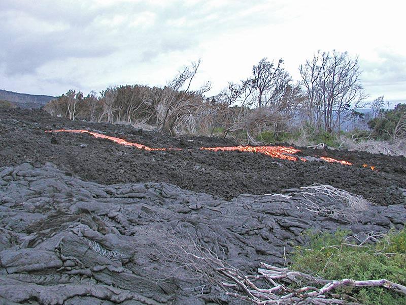 This is a photo of a channel of lava flowing across `a`a of Banana flow in small kipuka.