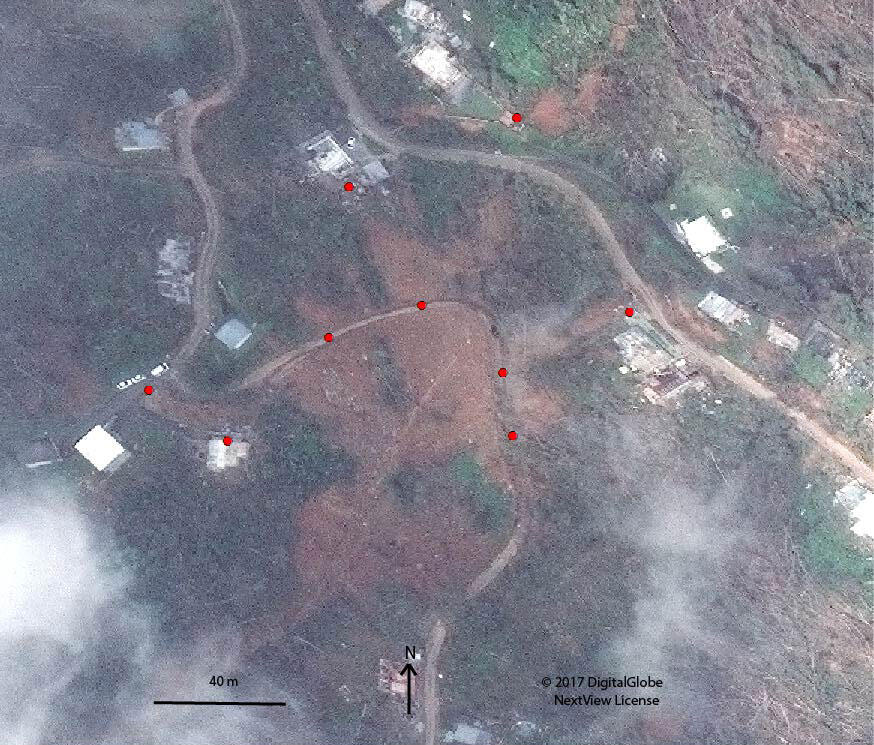 Excerpt of satellite image showing landslide impacts near Highway PR-406 and buildings in the Anasco Municipality.