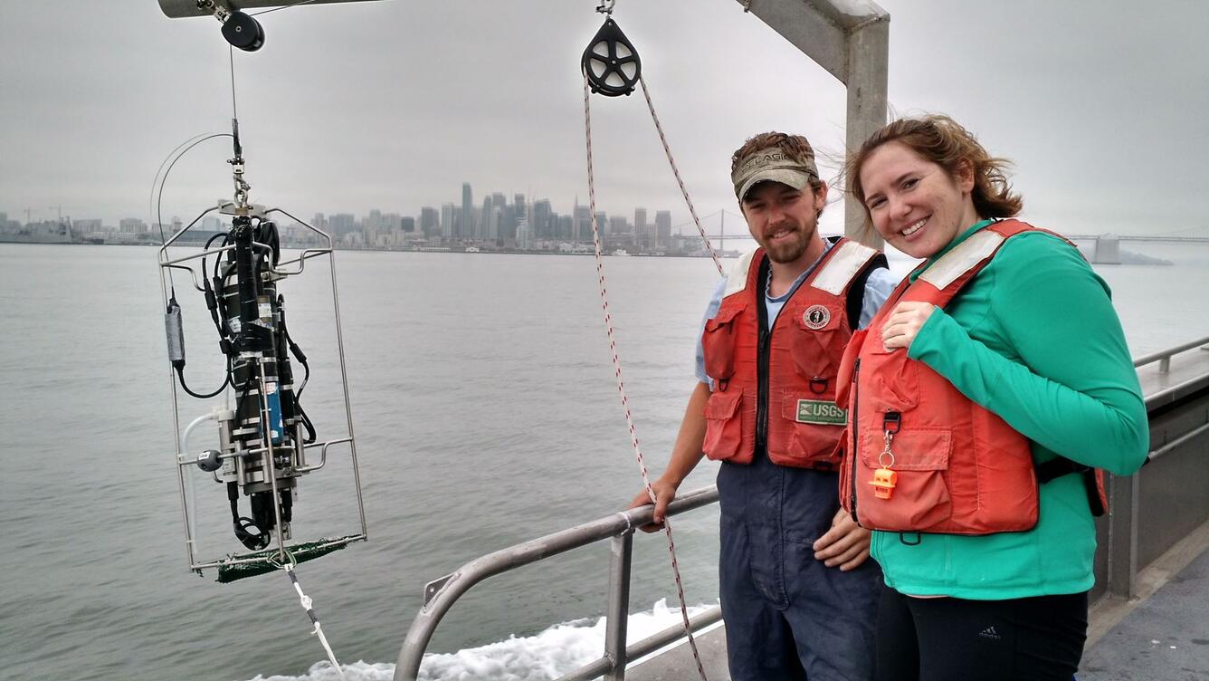 Two USGS scientists deploying a Conductivity, Temperature, and Depth (CTD) package in San Francisco Bay.