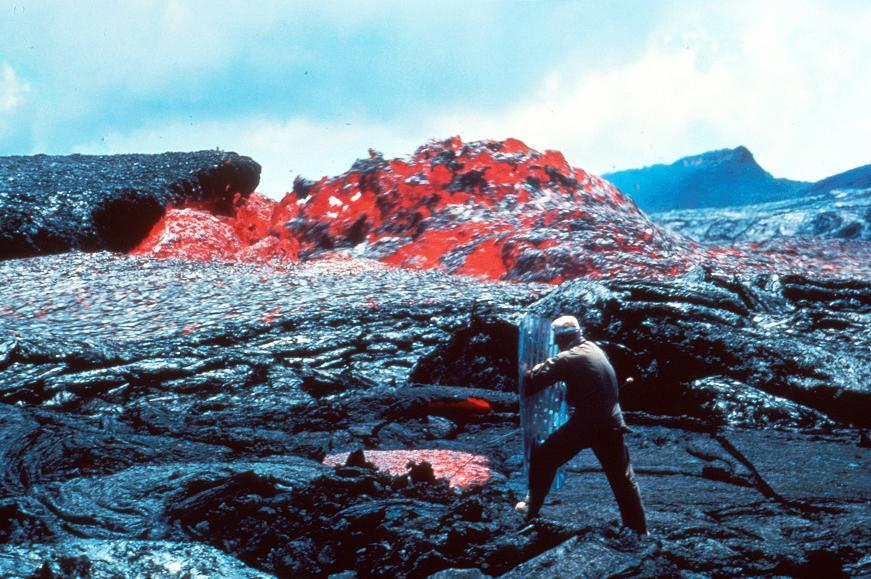 scientist shown taking a lava temp using a heat shield