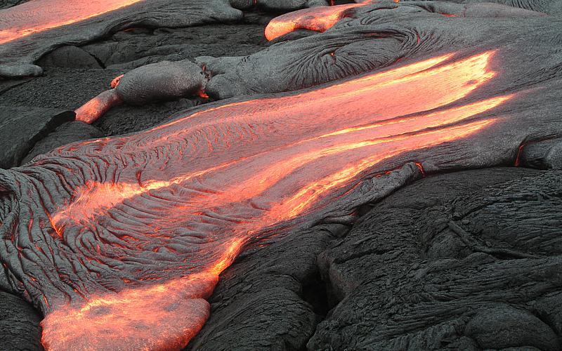 Lava pouring from under crust, cooling en route, and forming crust