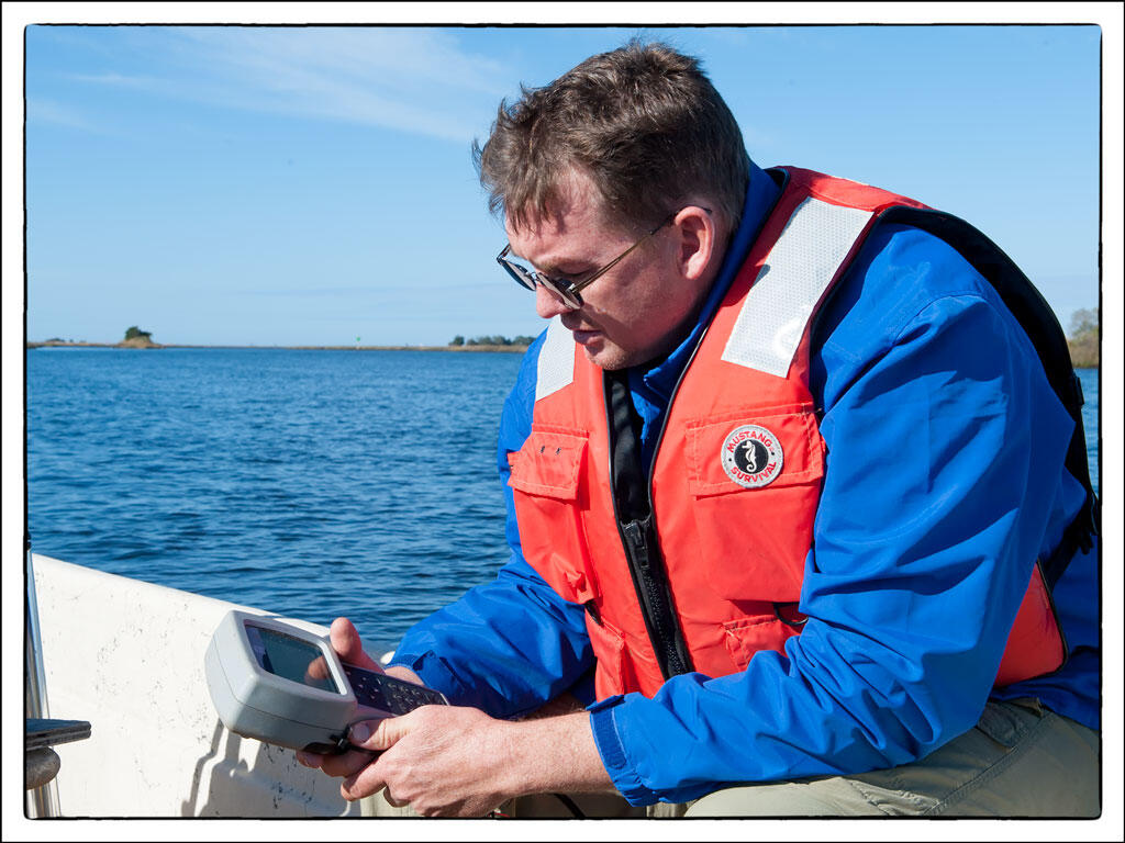 Photo of biologist Mike Randall with YSI 650 in Suwannee Sound