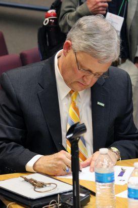 Color photo of EROS Director Frank Kelly at the L8 hand--off ceremony