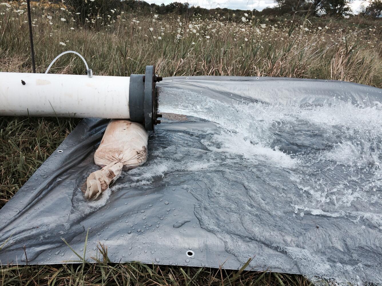 Photo of the discharge from an aquifer pumping test