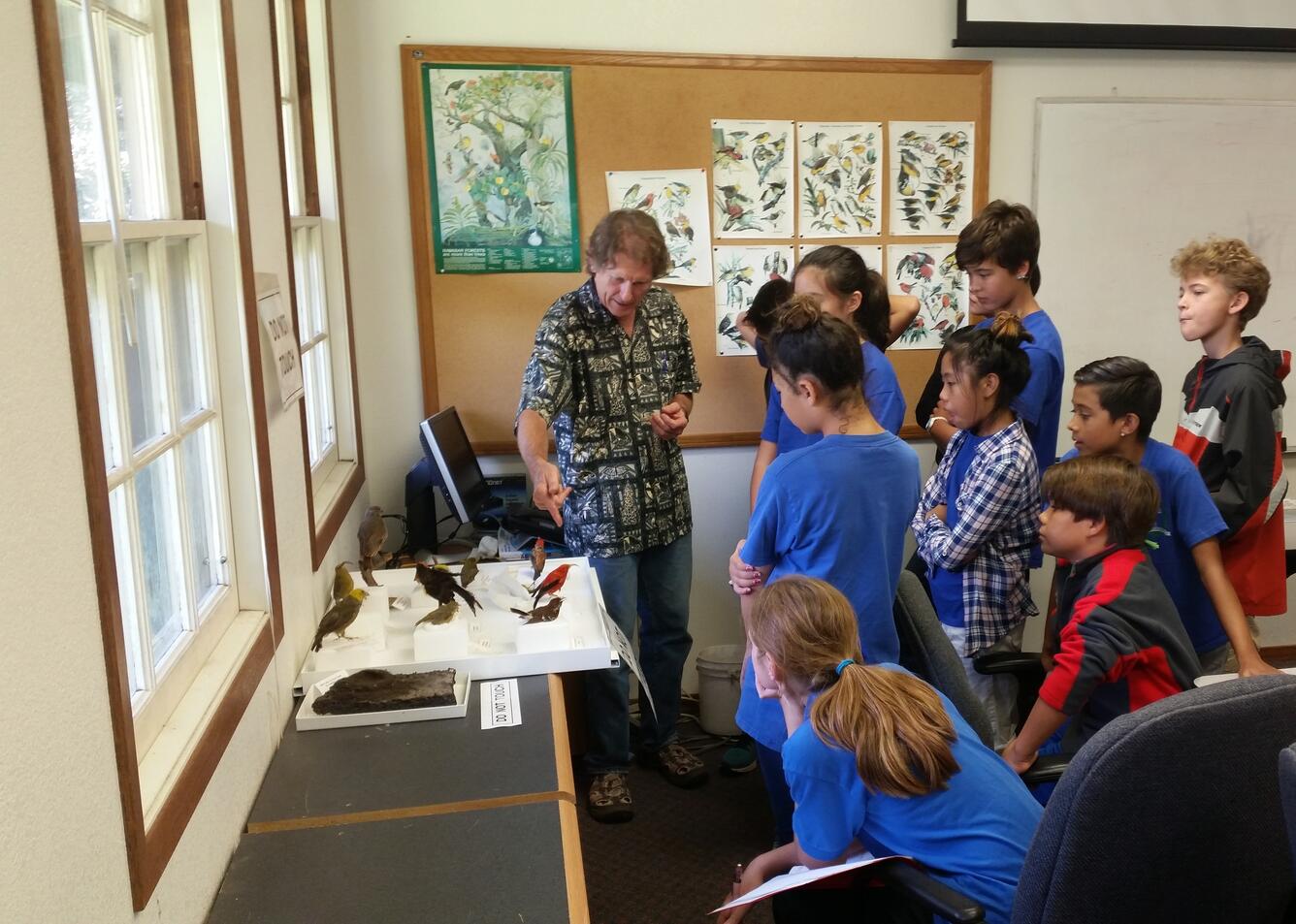 Dr. Paul Banko shows extinct study skins of Hawaiian Forest birds to school children
