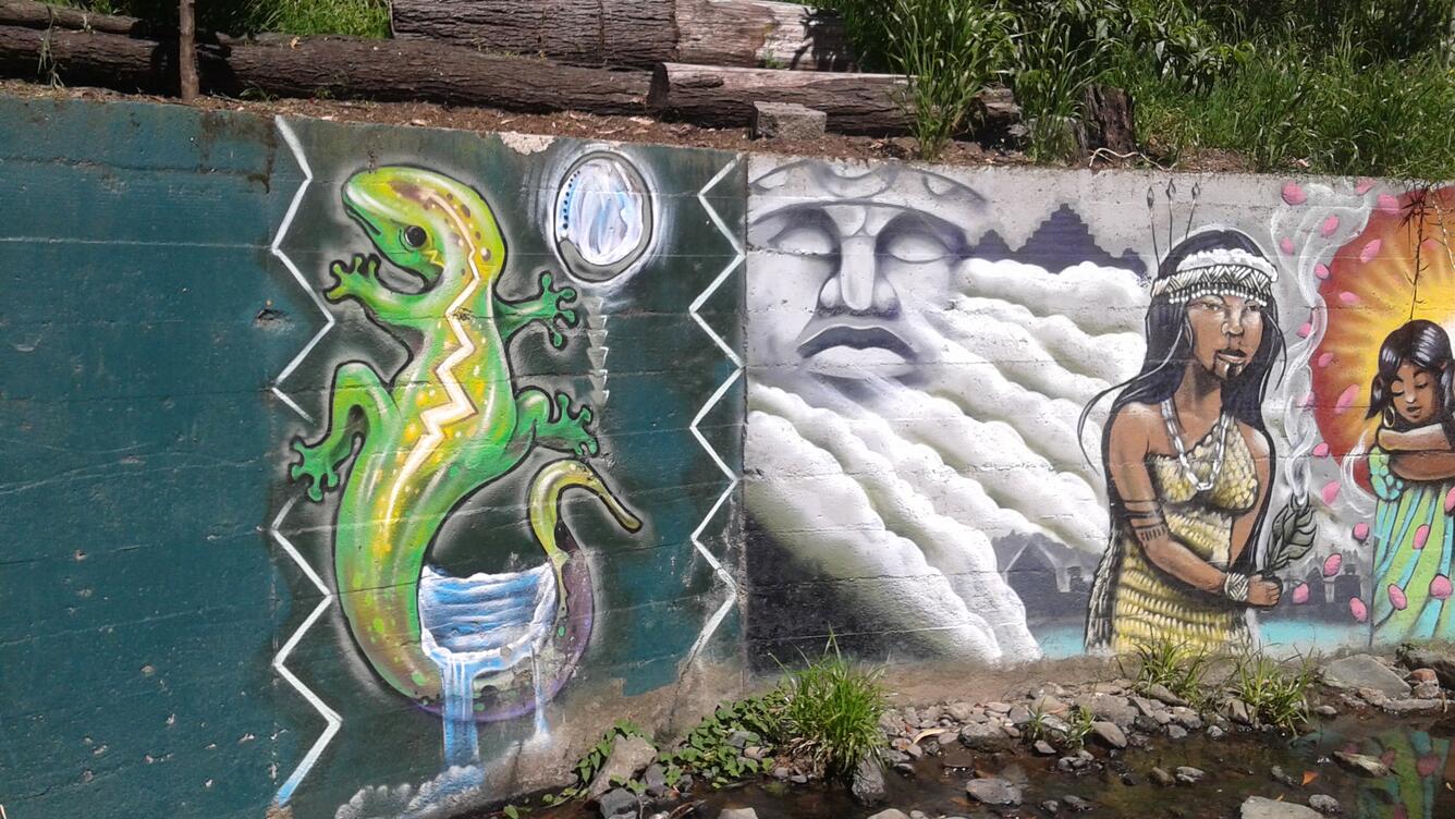 Urban art along stream retaining wall