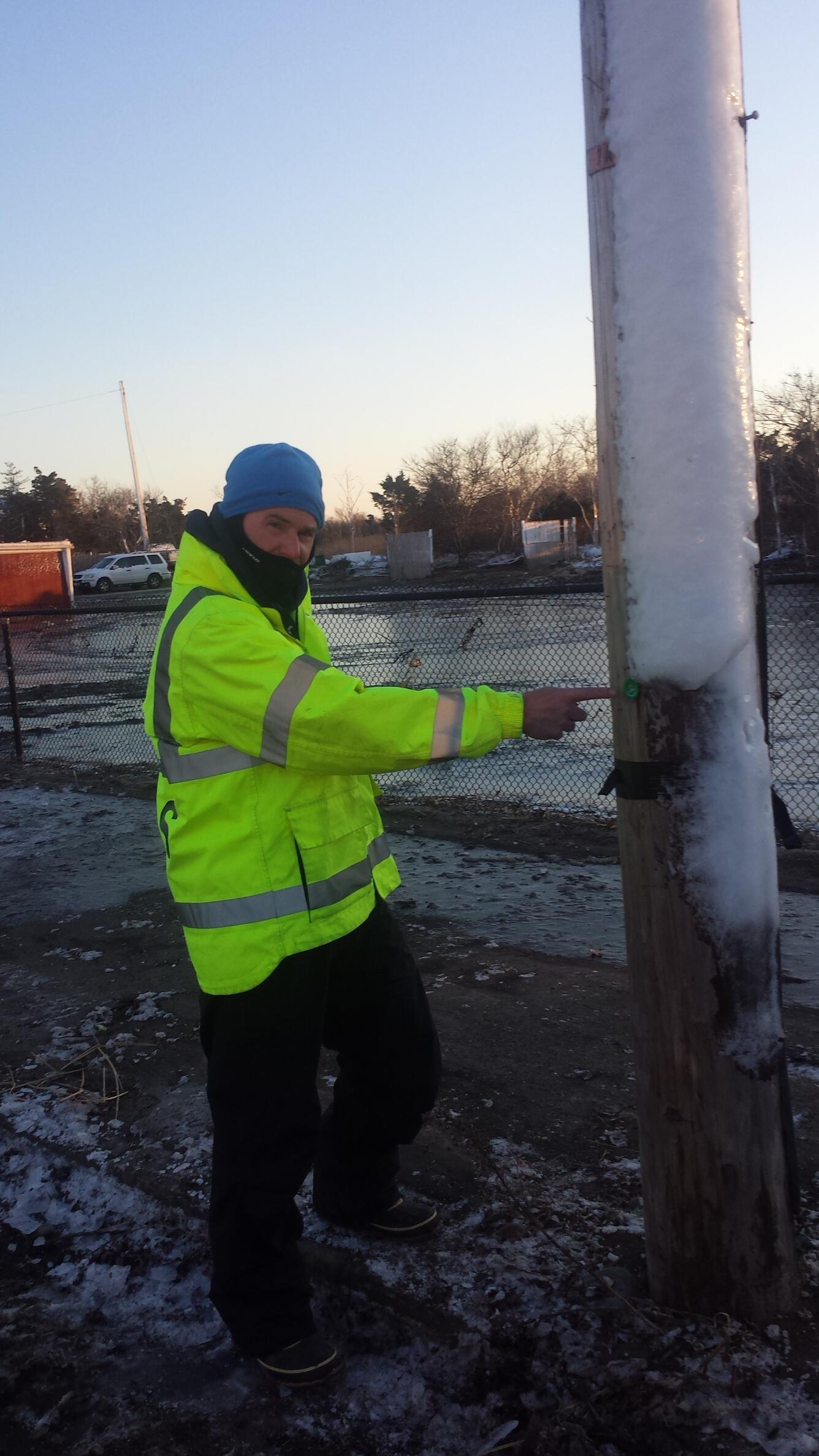 Photo of hydrologist, Gardner Bent, identifying high-water level from flood