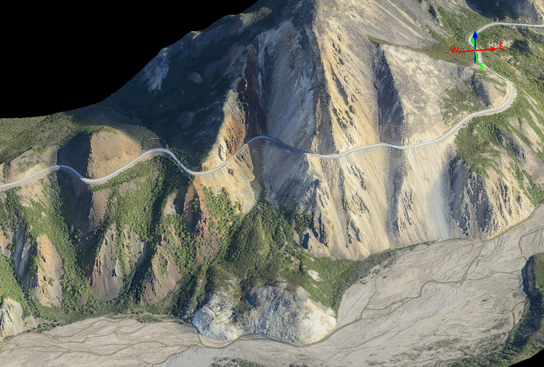 aerial photo of mountainside with road cutting across