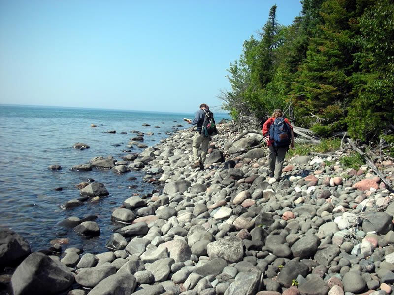 Ecologists and mappers traveling along the Lake Superior shore in Apostle Islands National Lakeshore.