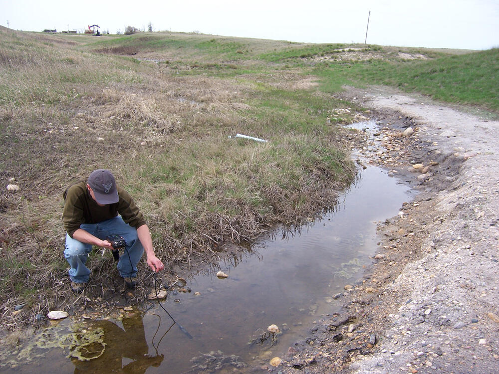 Todd Preston, USGS, measuring specific conductance of contaminated groundwater inflow.