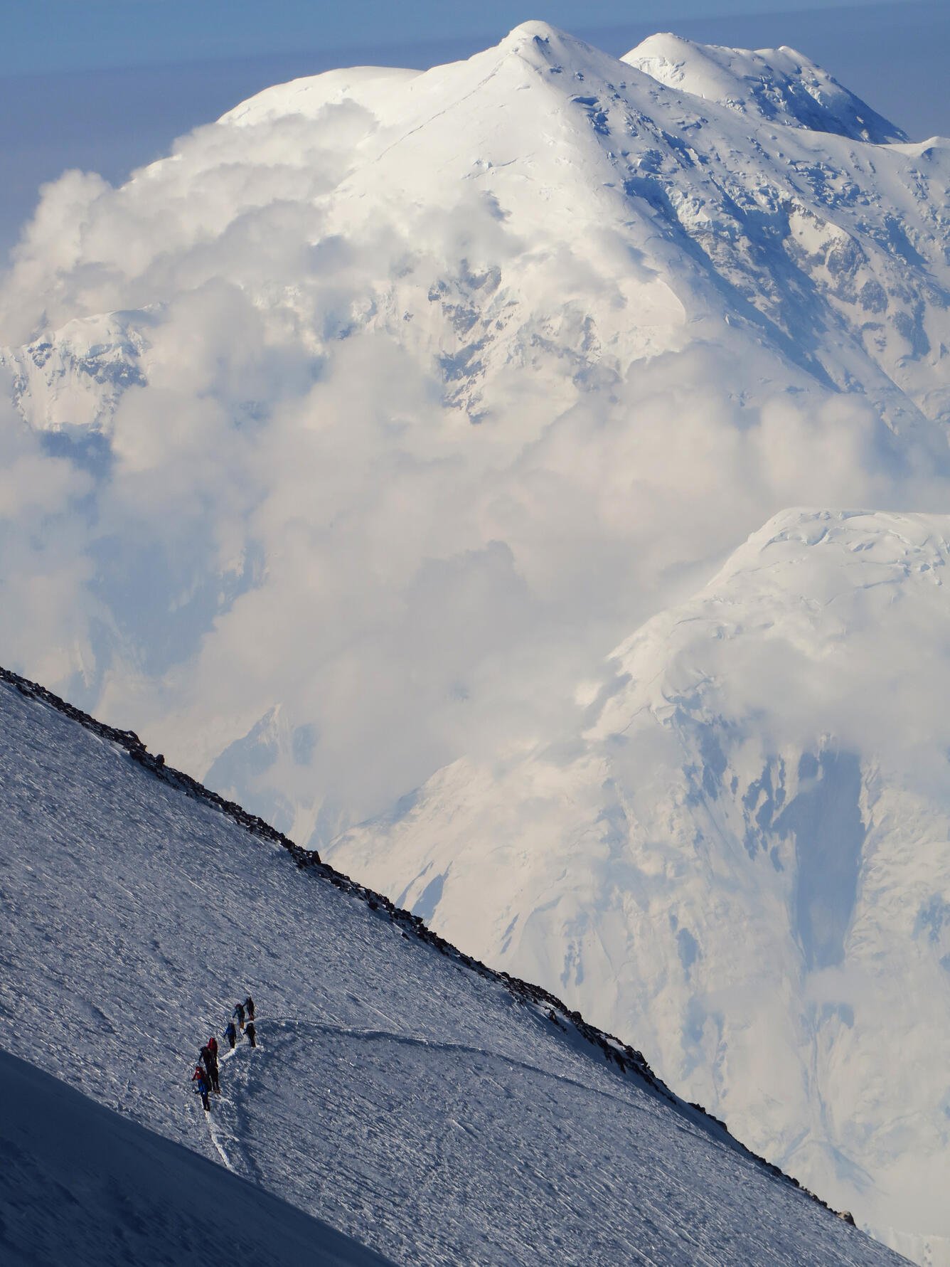 Leaving the 17,000 foot camp for the final leg, crossing the “Autobahn”. Climbers perform what is called a running belay. The fi