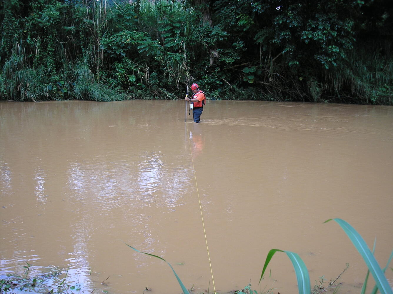 Technician making discharge measurements