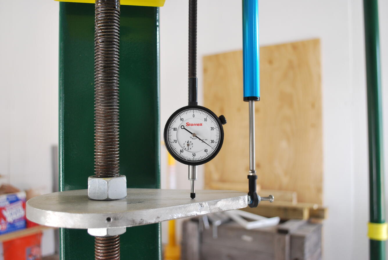 Virginia analog dial gage and a digital linear potentiometer (blue barrel) used to measure land-surface movement.