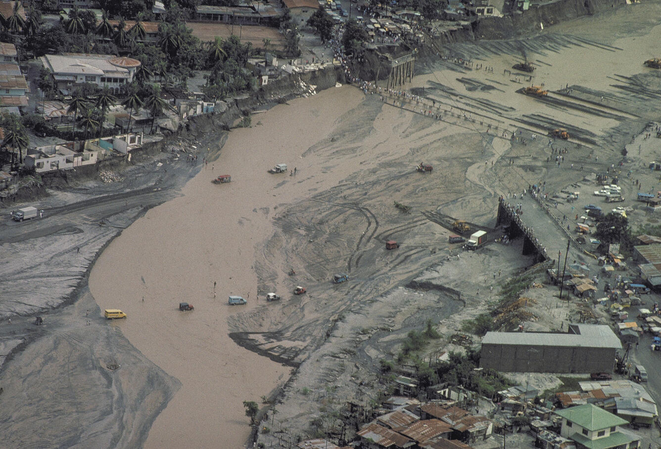 aerial view of flooded muddy river with washed out bridges