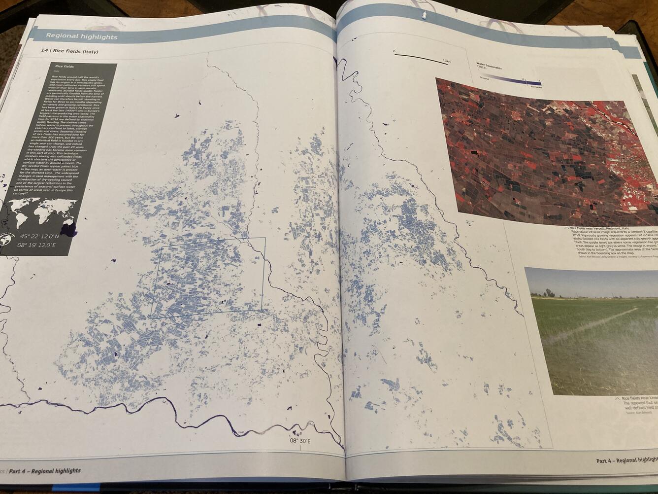 Color photo of "Atlas of Global Surface Water Dynamics" book pages