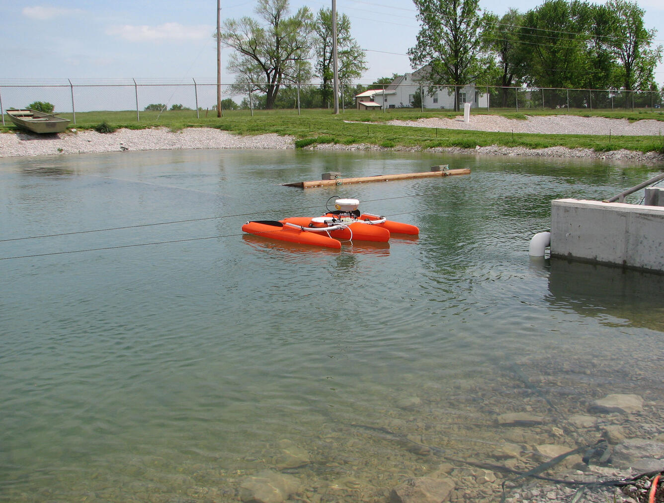 A River Ray ADCP deployed on a catamaran is shown mapping the CERC sturgeon study pond’s water currents