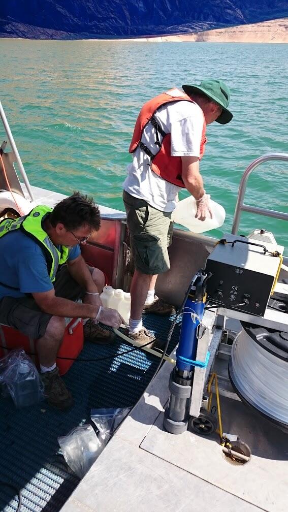 Two scientists collecting water samples from a boat on Lake Powell, Arizona.