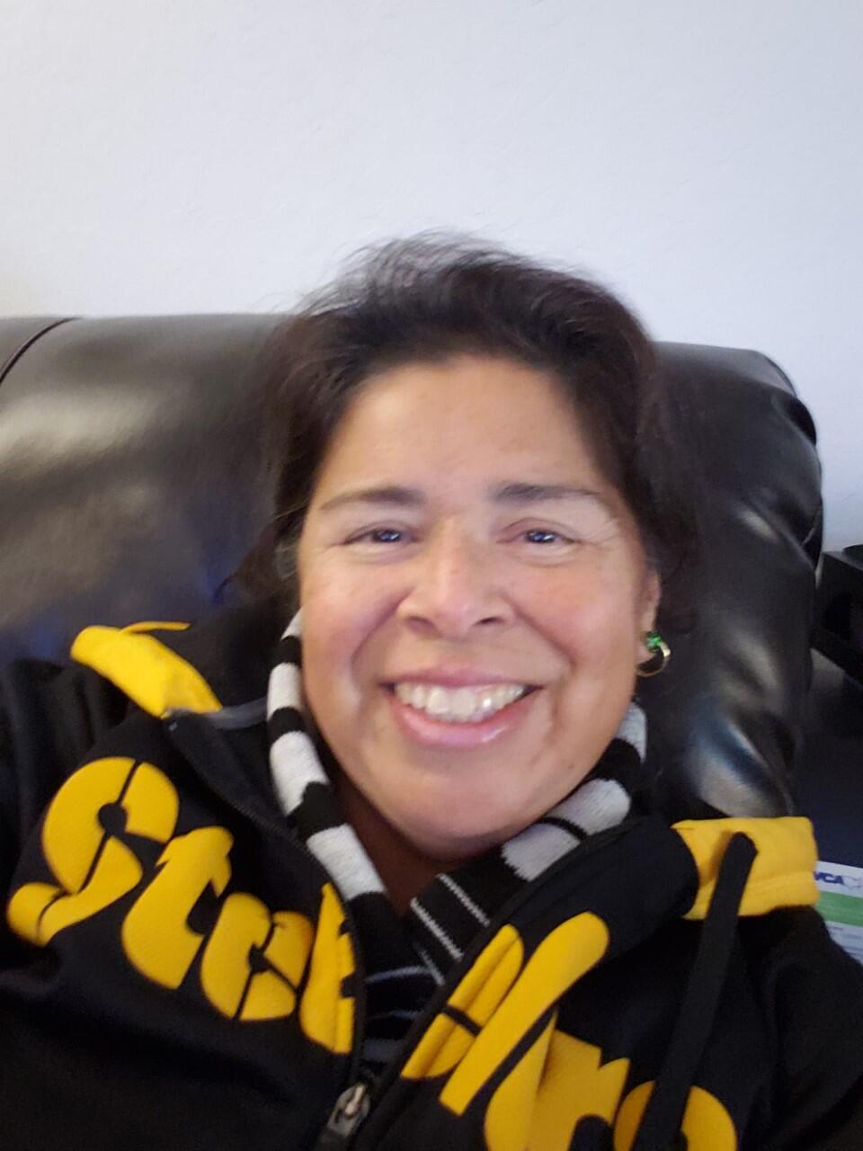 A woman smiles for the camera.