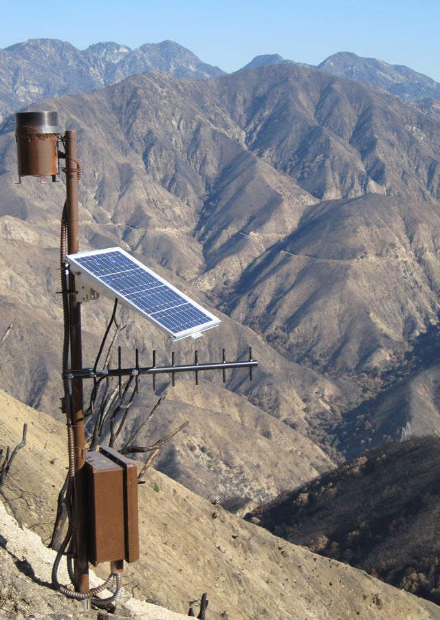 Landslide monitoring station with the San Gabriel mountains in the background, post wildfire with no vegetation
