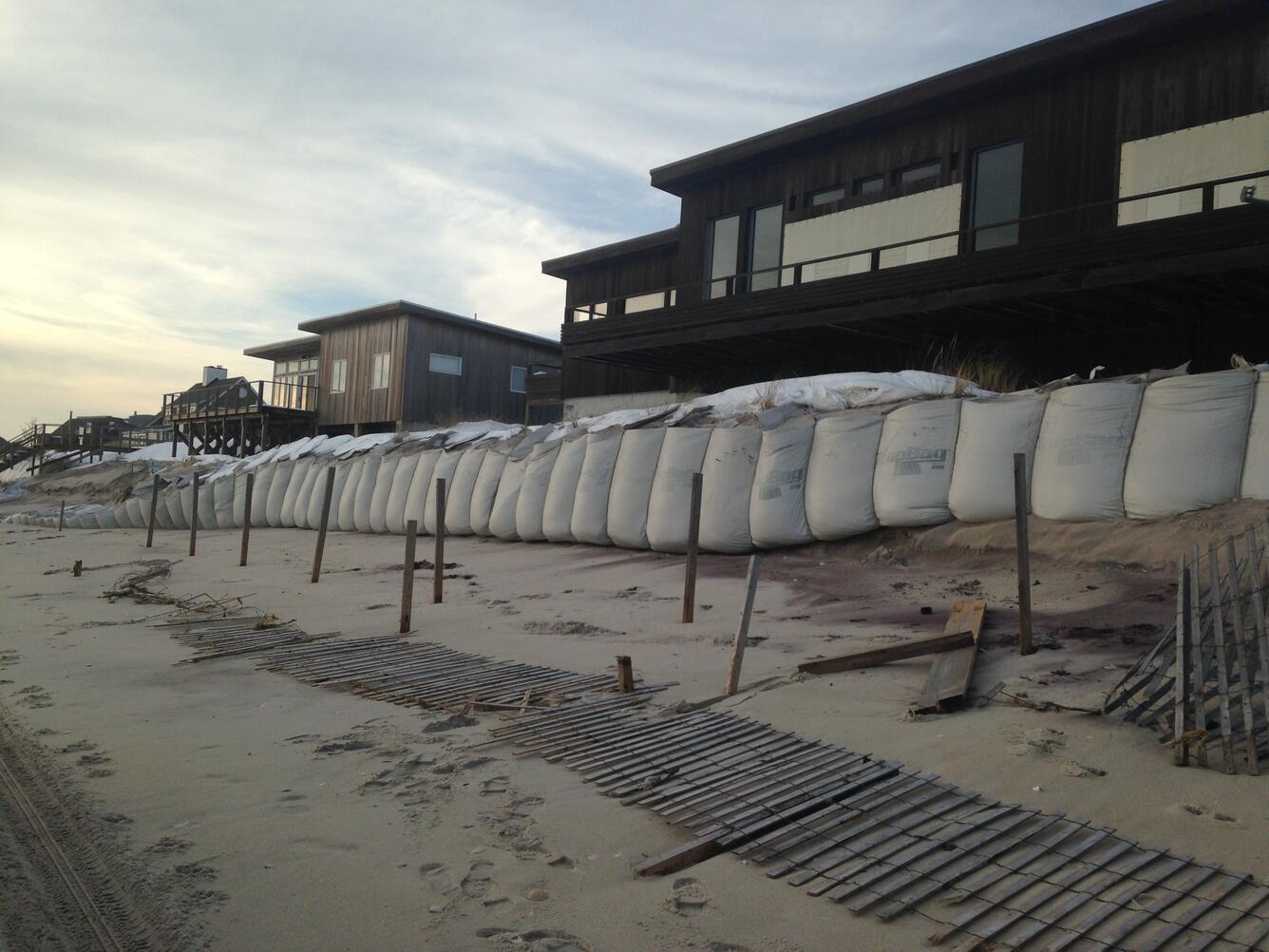Sand bags protecting coastal area with homes