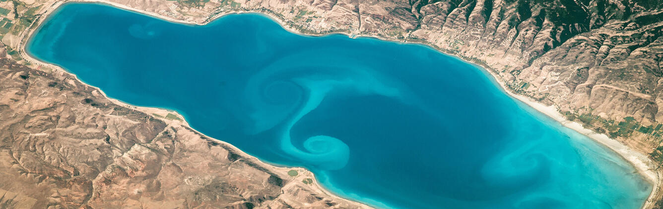 NASA image of Bear Lake with beautiful swirls in blue water showing mixing