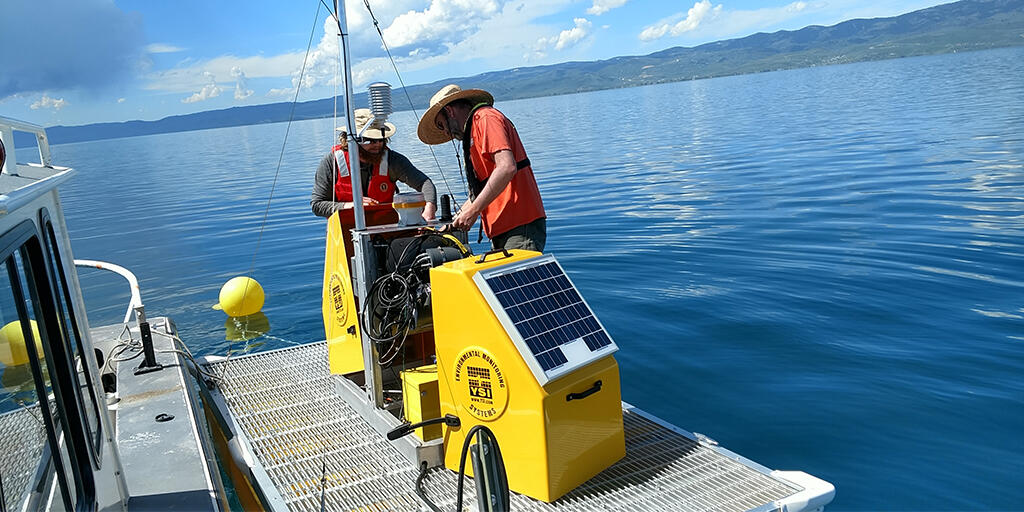 Technicians work on water-quality instrumentation deployed on platforms on Bear Lake, Utah