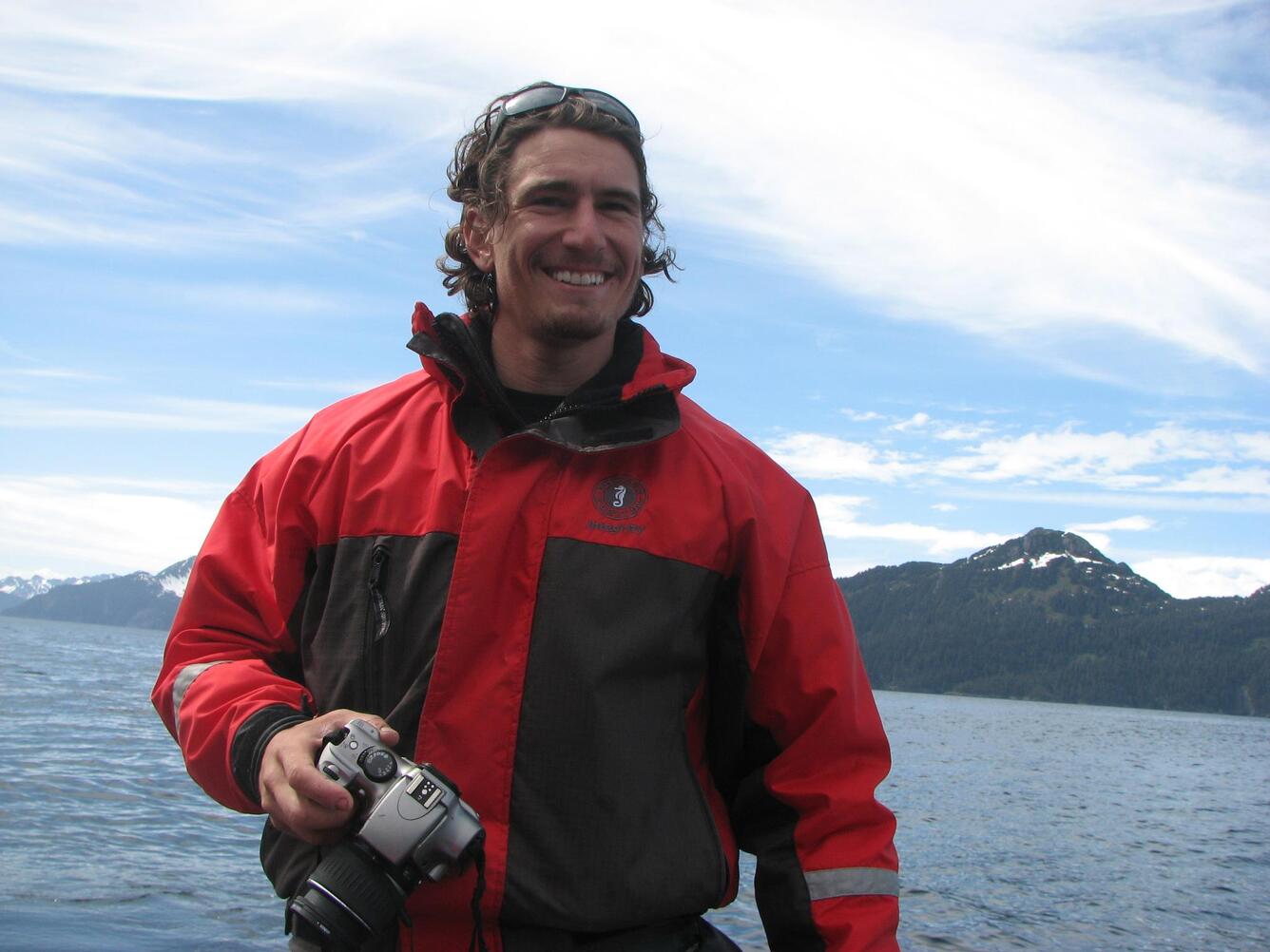 Ben Weitzman with a camera and the marine nearshore ecosystem in the background