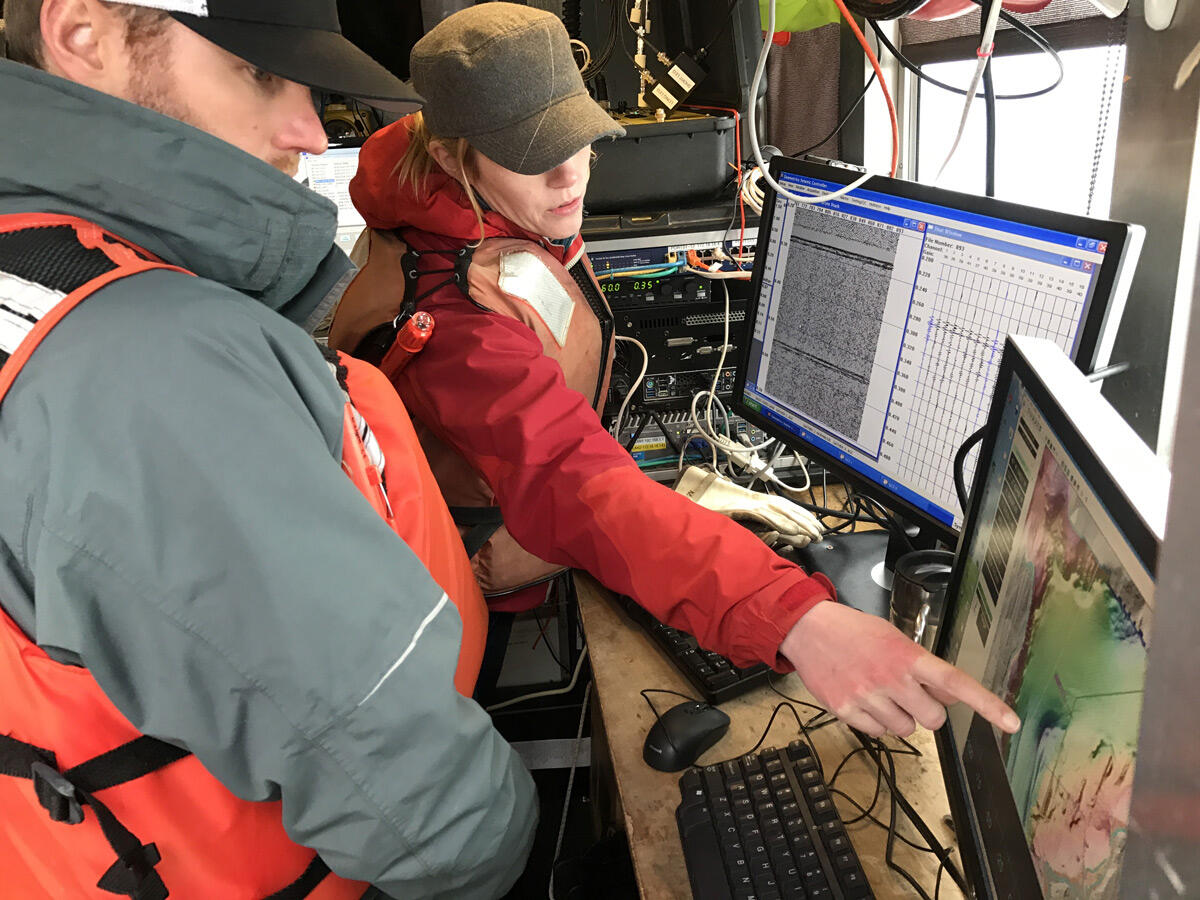 two people looking at computer monitors