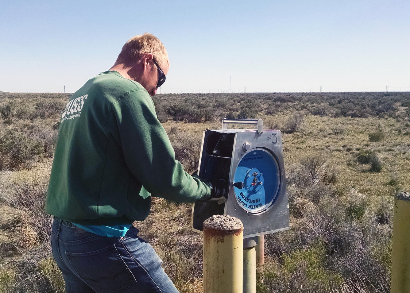 Hydrologic technician collecting a groundwater level measurement