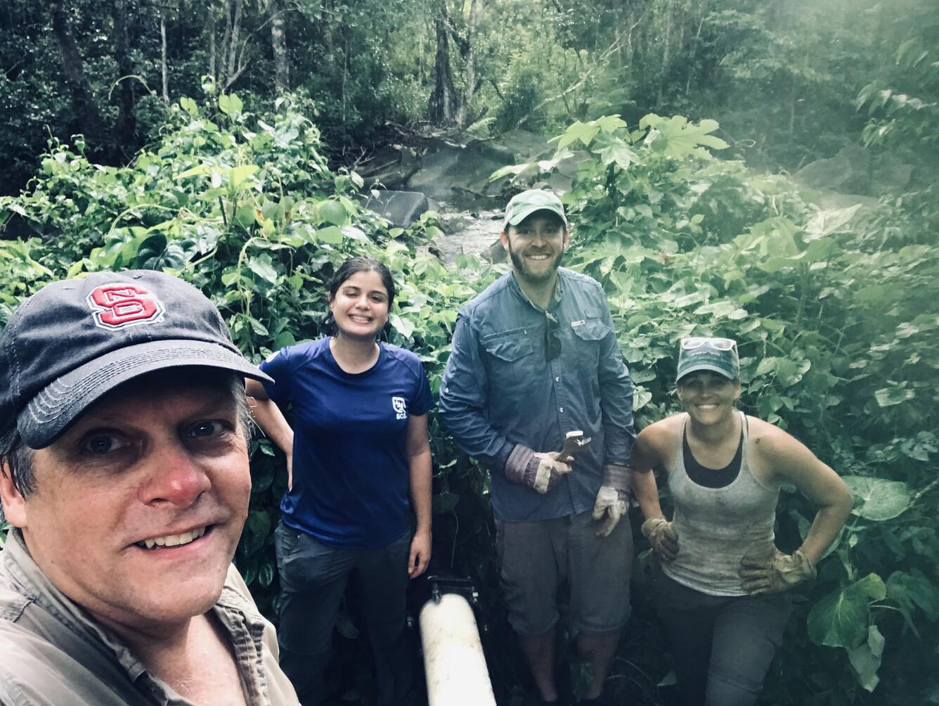 Dr. Tom Kwak, Dr. Gus Engman, Ámbar Torres Molinari, and Bonnie Myers working on rebuilding artificial streams.