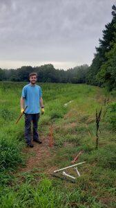 Master’s student Bradley Lewis collects a core sample