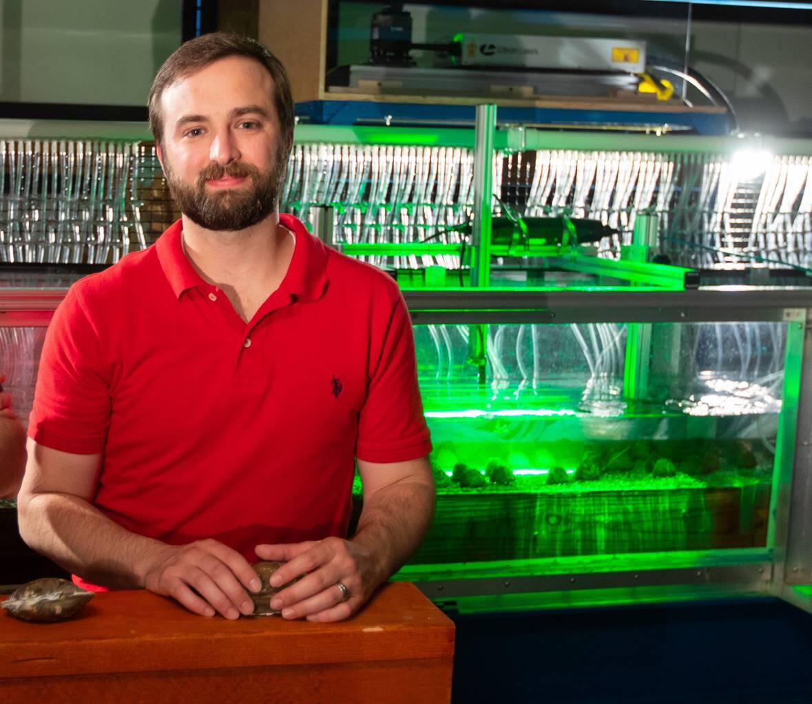 USGS research engineer Brandon Sansom in front of a hydraulic flume at the University at Buffalo