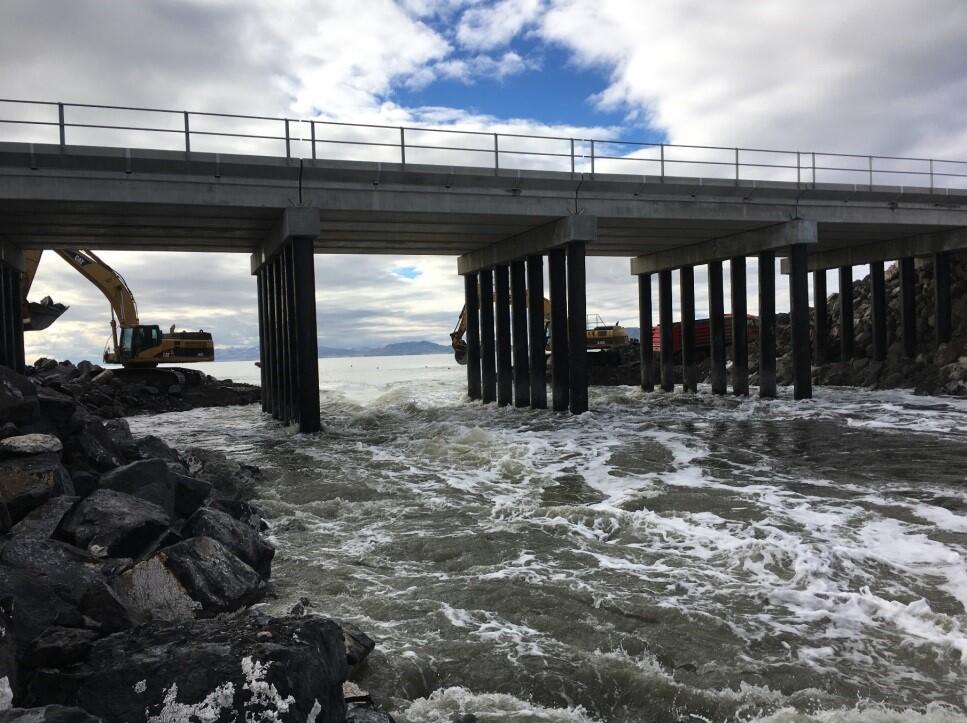 Water flowing rapidly towards camera shortly after the Great Salt Lake causeway was breached.