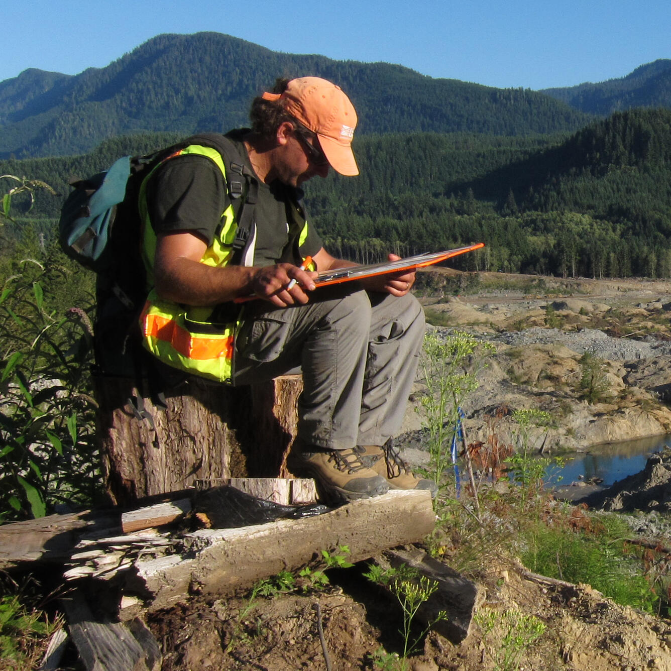 Brian Collins reviewing paperwork in field