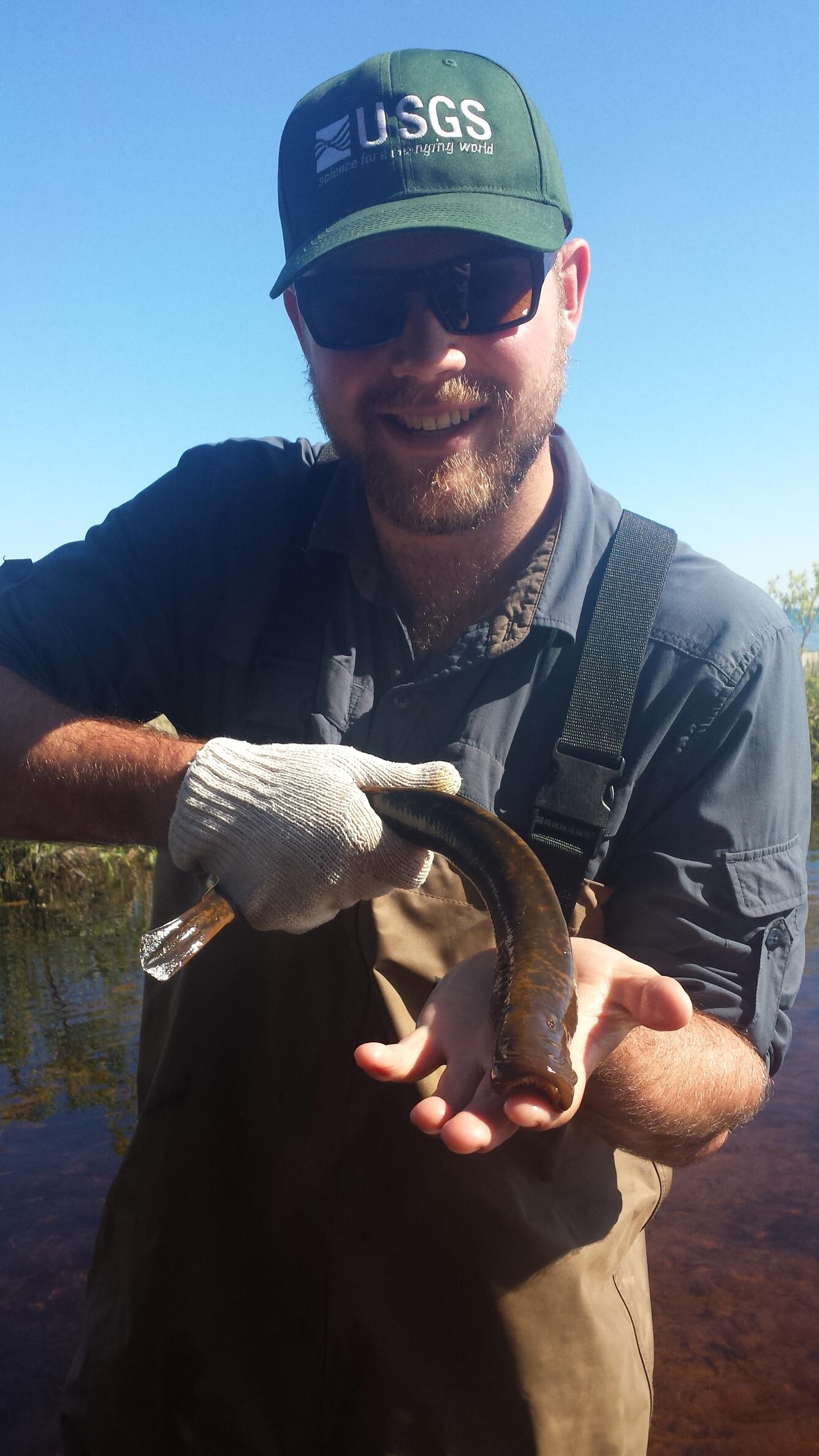 NAGT/USGS Intern Brian Snow holding Lamprey