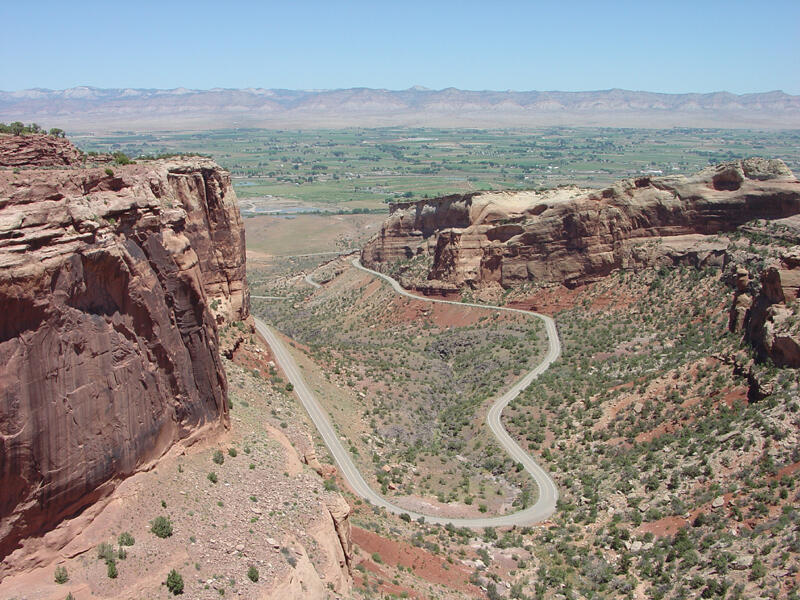 This is a photo of a view looking down on the Rim Rock Drive-the main route through the national monument.