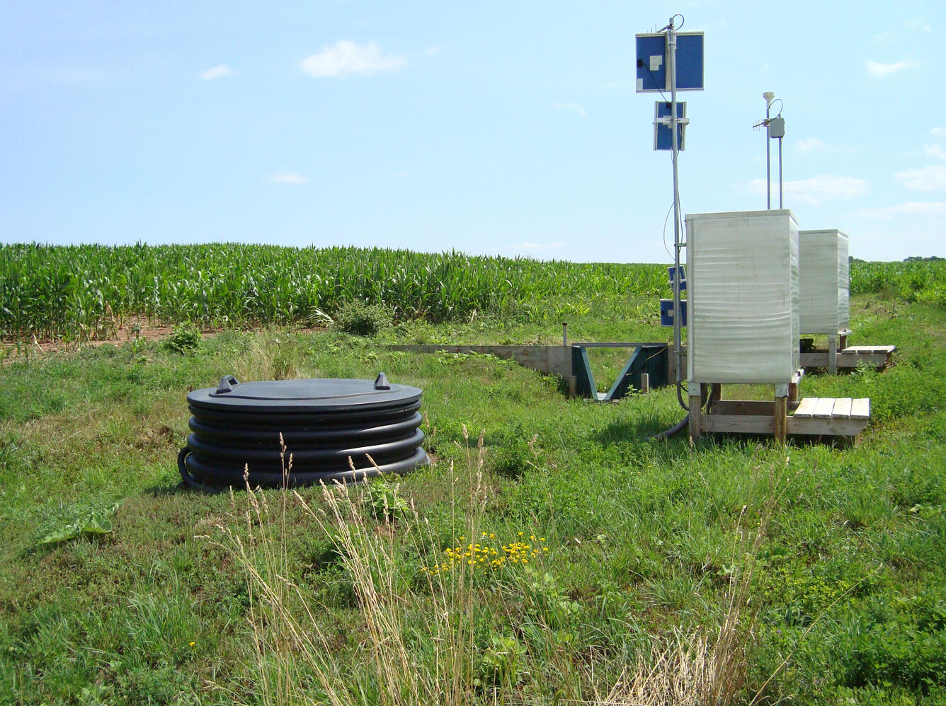 Photo of edge-of-field subsurface tile and surface sites.
