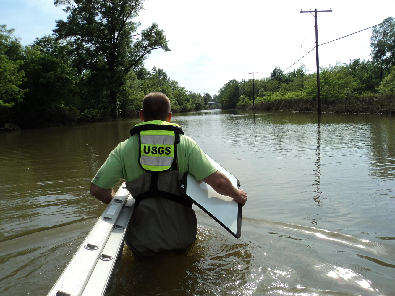 USGS scientist wading in high water