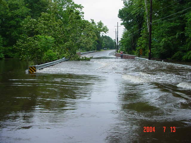 Hydrographer measuring off of bridge in the overflow waters