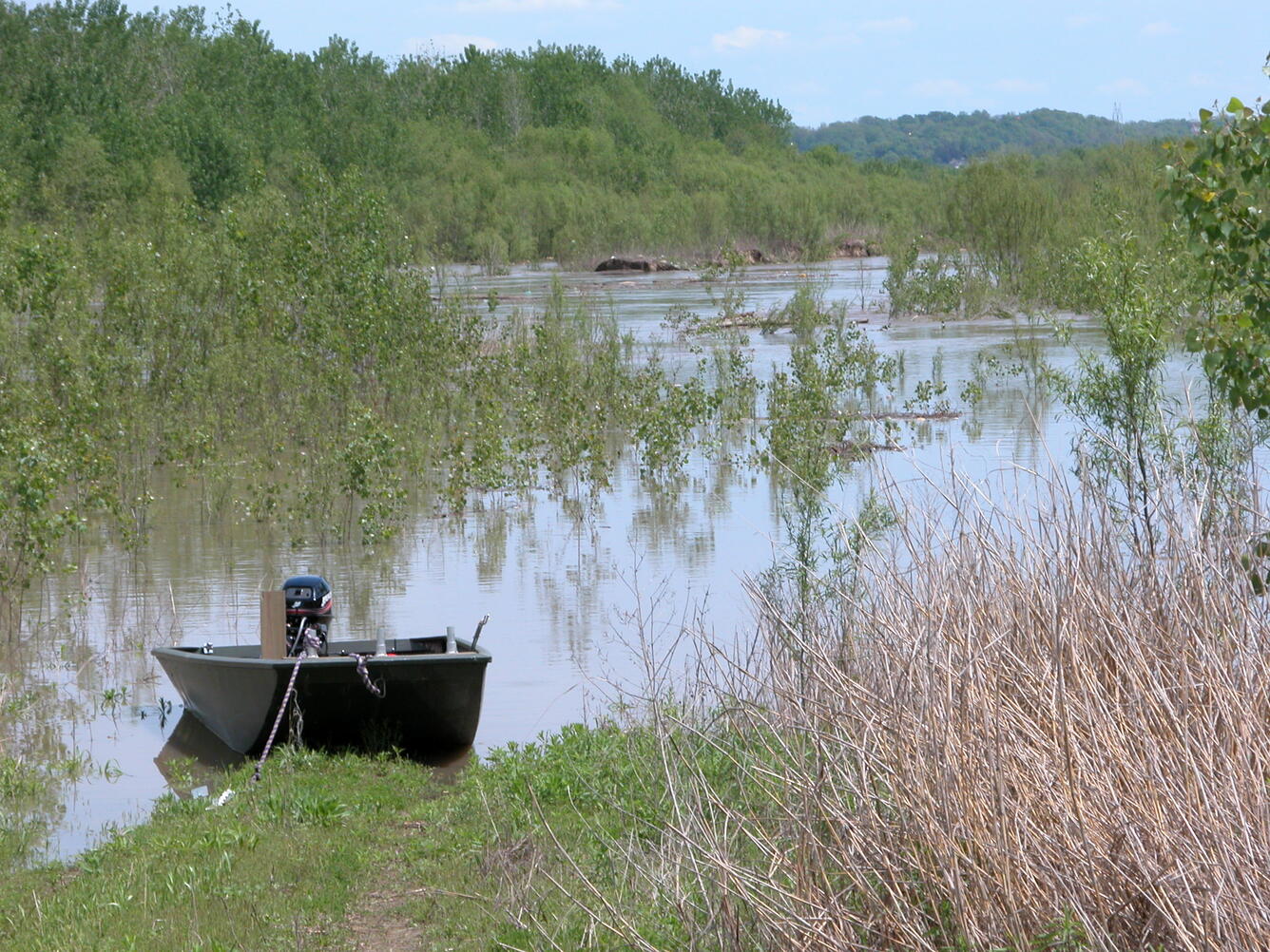 A boat parked in a floodplain shows the extent of flooding during a high water event. 