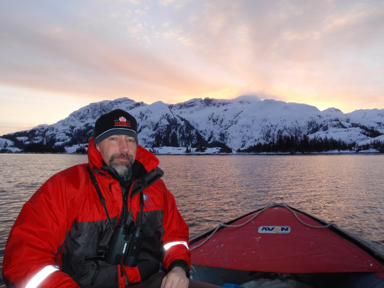Dan Esler in a boat with a mountain in the background