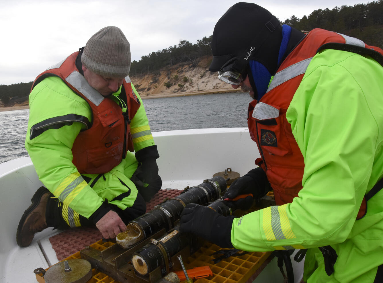 Dann Blackwood and Jon Borden inspect a current meter retrieved from the ocean using the research boat Muddy Waters