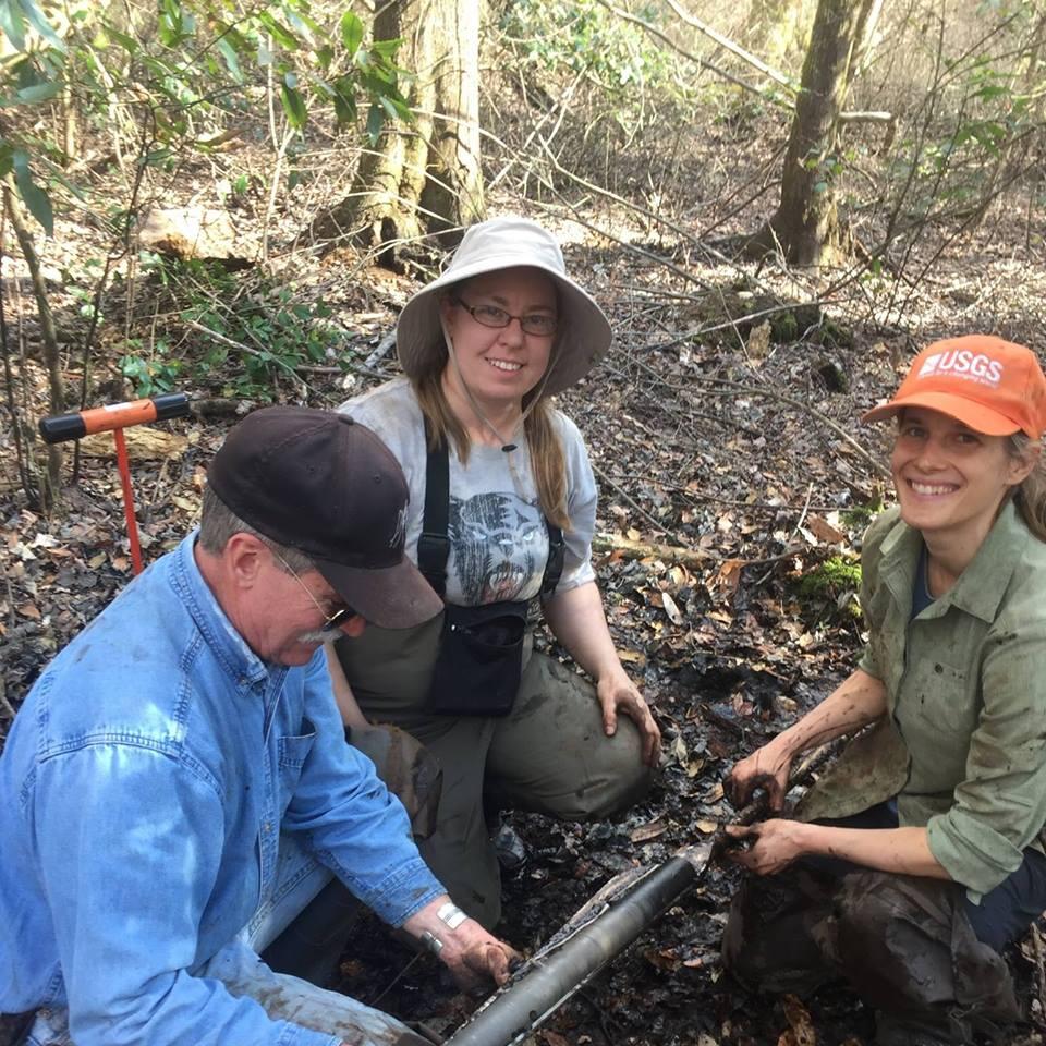 Photo of researchers in the field collecting core samples