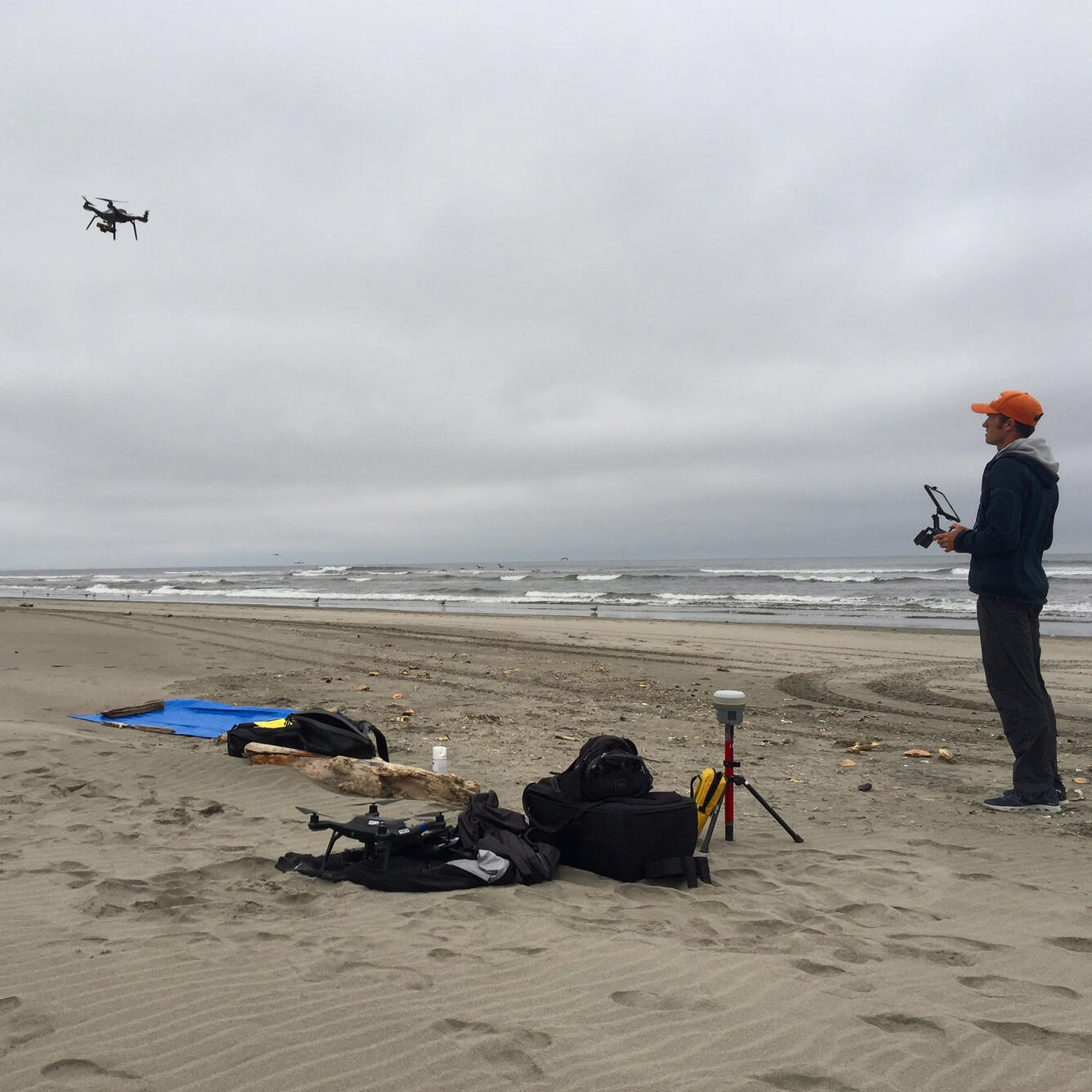 Josh Logan operates a drone carrying a precision GPS and special camera to map the shore at Long Beach, Washington